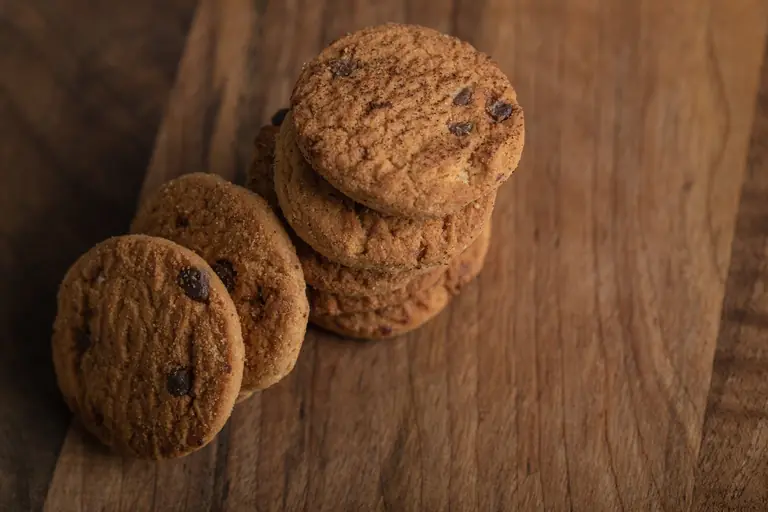 Pile de cookies aux pépites de chocolat sur une planche en bois